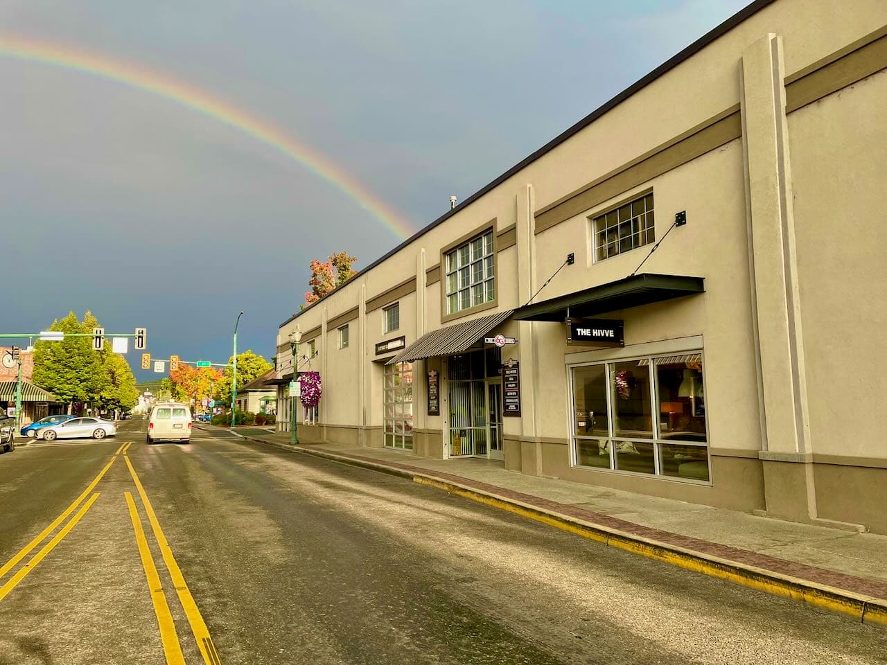 The Hivve building exterior on G Street in downtown Grants Pass with a rainbow overhead
