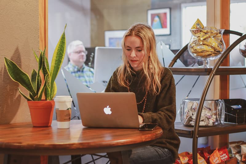 Woman working on her laptop at a coworking desk at The Hivve